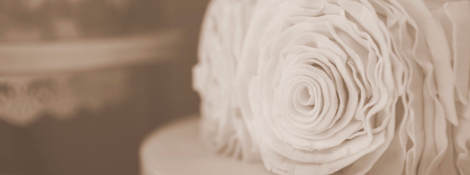 three tier wedding cake with ruffle rose